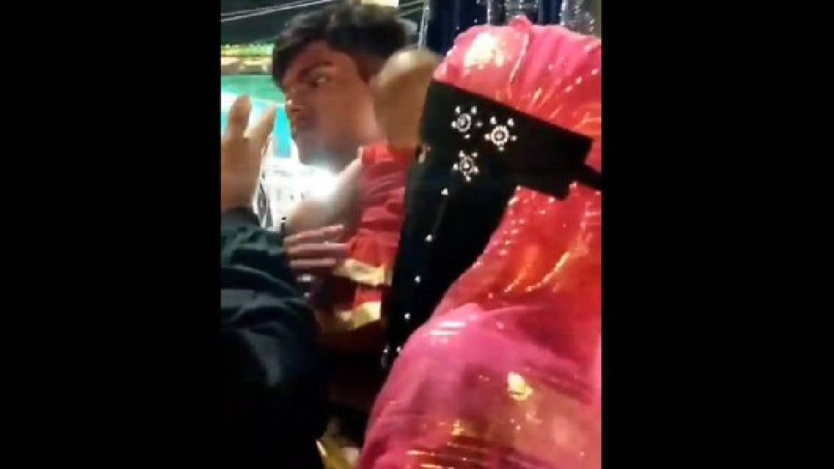 A group of youths aggressively surrounding and confronting an interfaith couple carrying an infant child near the Charminar marketplace in Hyderabad